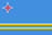 The flag of Aruba is blue, with two narrow, horizontal yellow stripes across the lower portion and a red four-pointed star outlined in white in the canton.