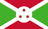 The flag of Burundi is divided by a white diagonal cross into four alternating triangular areas of red at the top and bottom, and green on the hoist and fly sides. A white circle, with three green-edged red six-pointed stars arranged to form a triangle, is superimposed at the center of the cross.