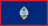 The flag of Guam is dark blue with a narrow red border on all four sides. Centered is a red-bordered, pointed, vertical ellipse containing a beach scene, a proa (outrigger canoe with sail), and a palm tree. The country's name in red is centered in the ellipse.